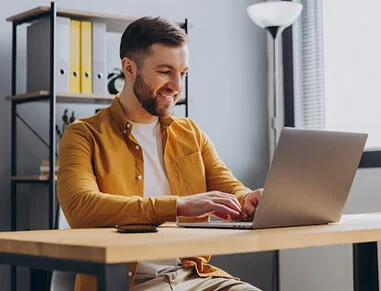 Guy Using Debt Rocket on Computer for Debt Relief